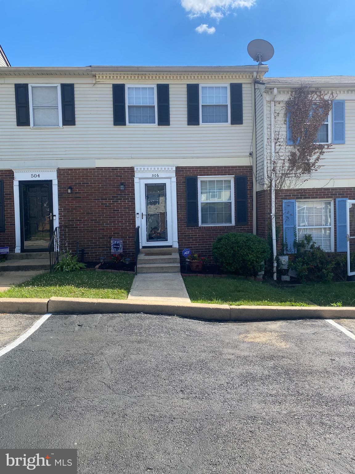 a view of a brick house with a yard