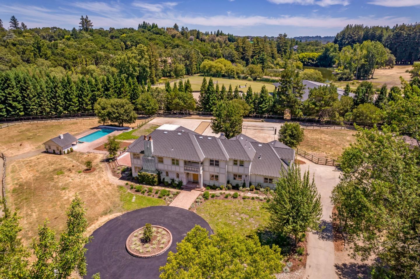 an aerial view of residential houses with outdoor space and river