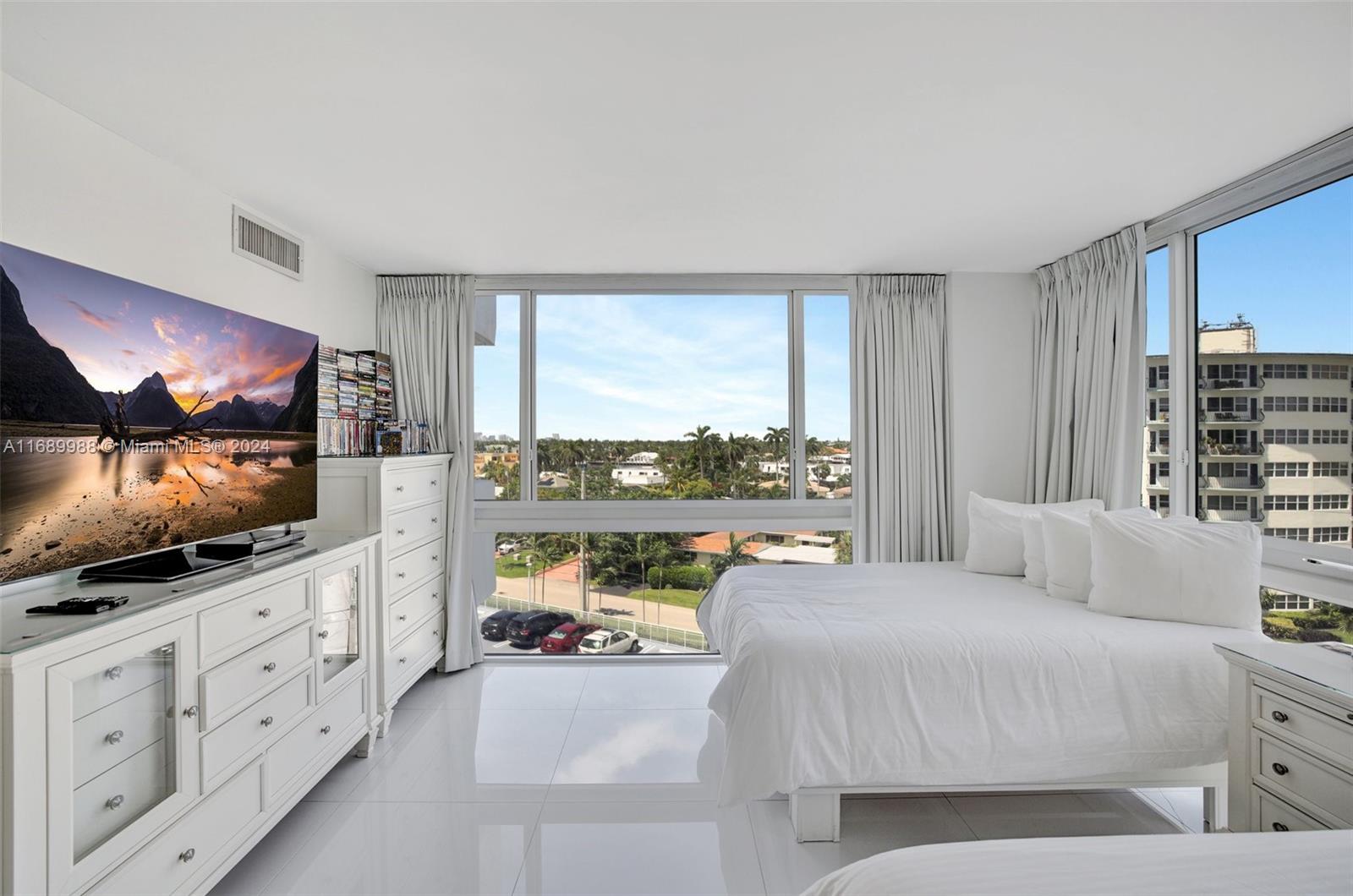 a bedroom with furniture and a flat screen tv