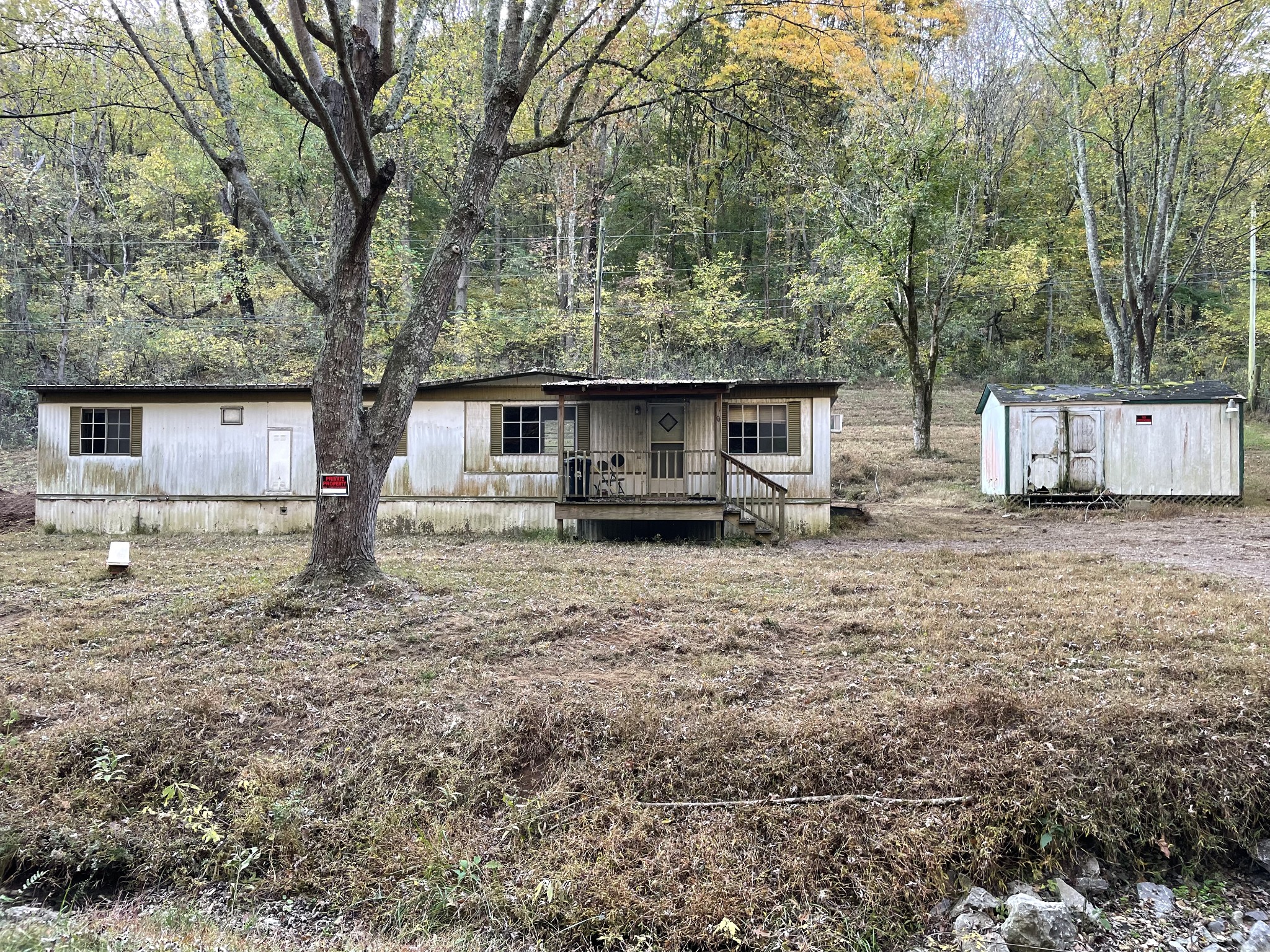 a view of a house with a yard and sitting area