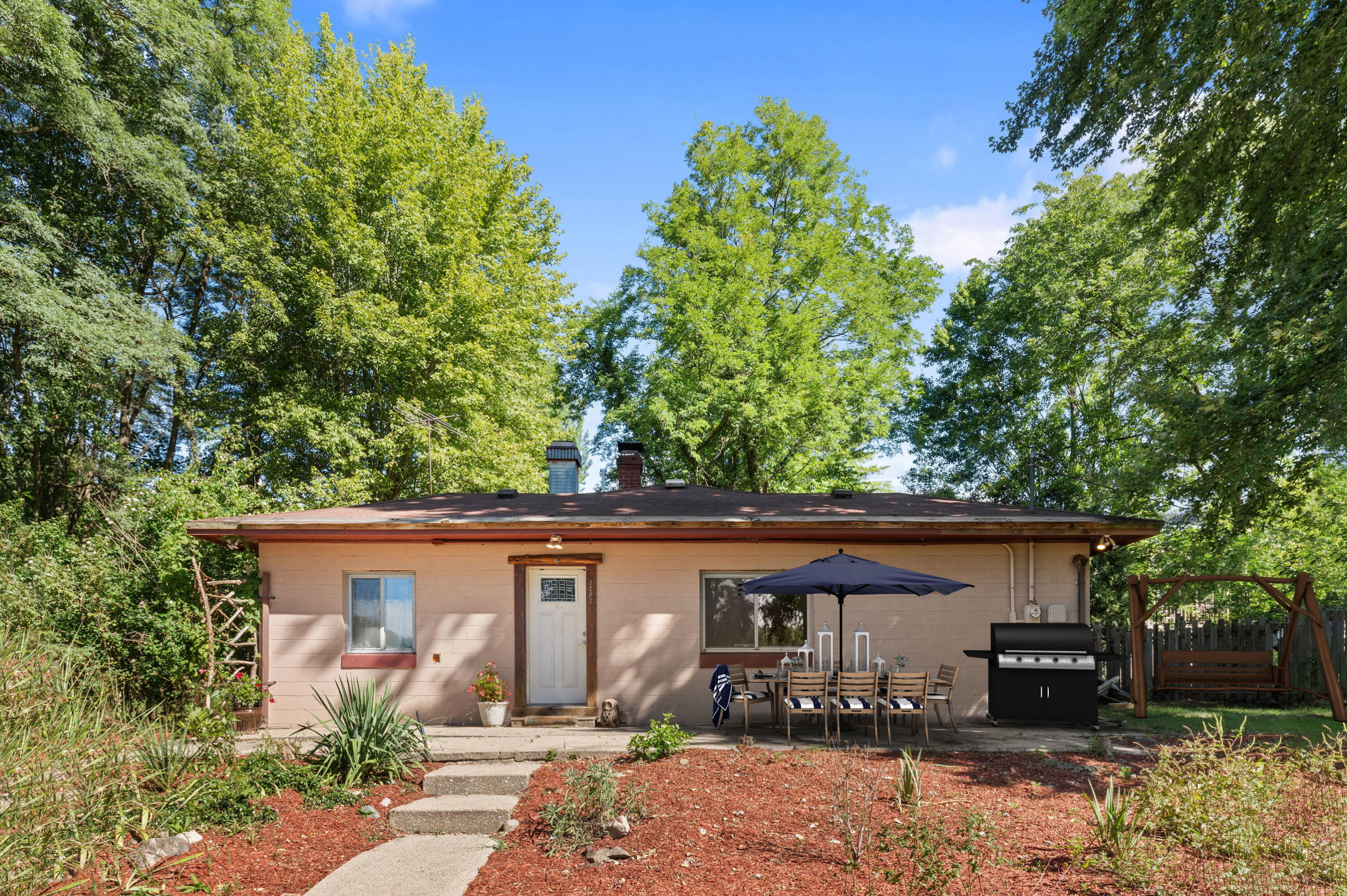 front view of a house with a tree