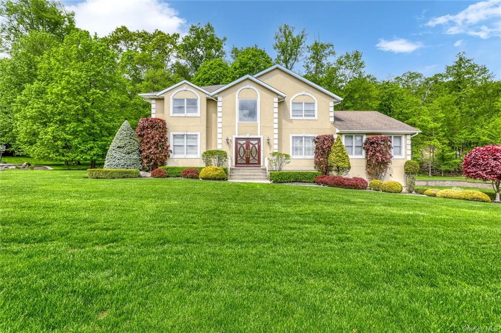 a front view of a house with a yard and garage