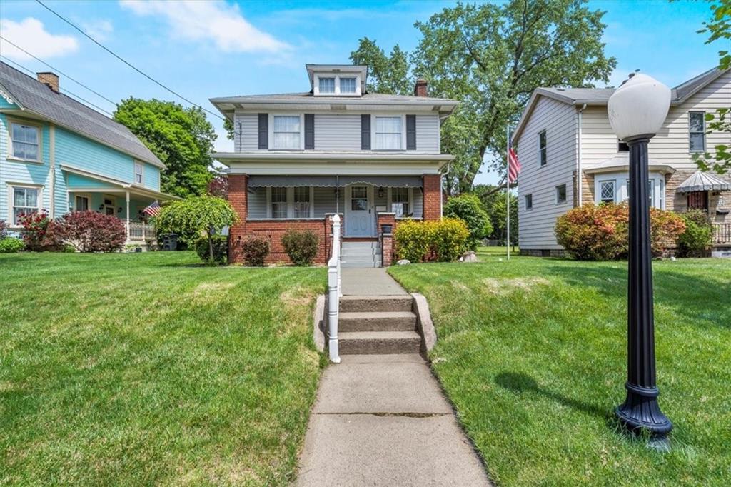 a front view of house with yard and green space