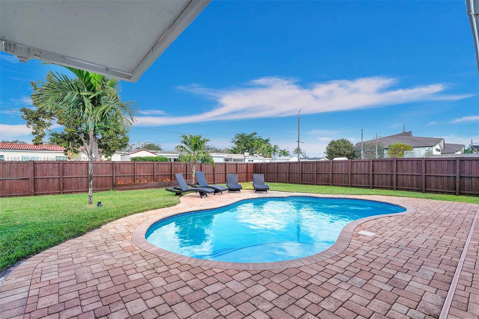 a view of a swimming pool and a yard