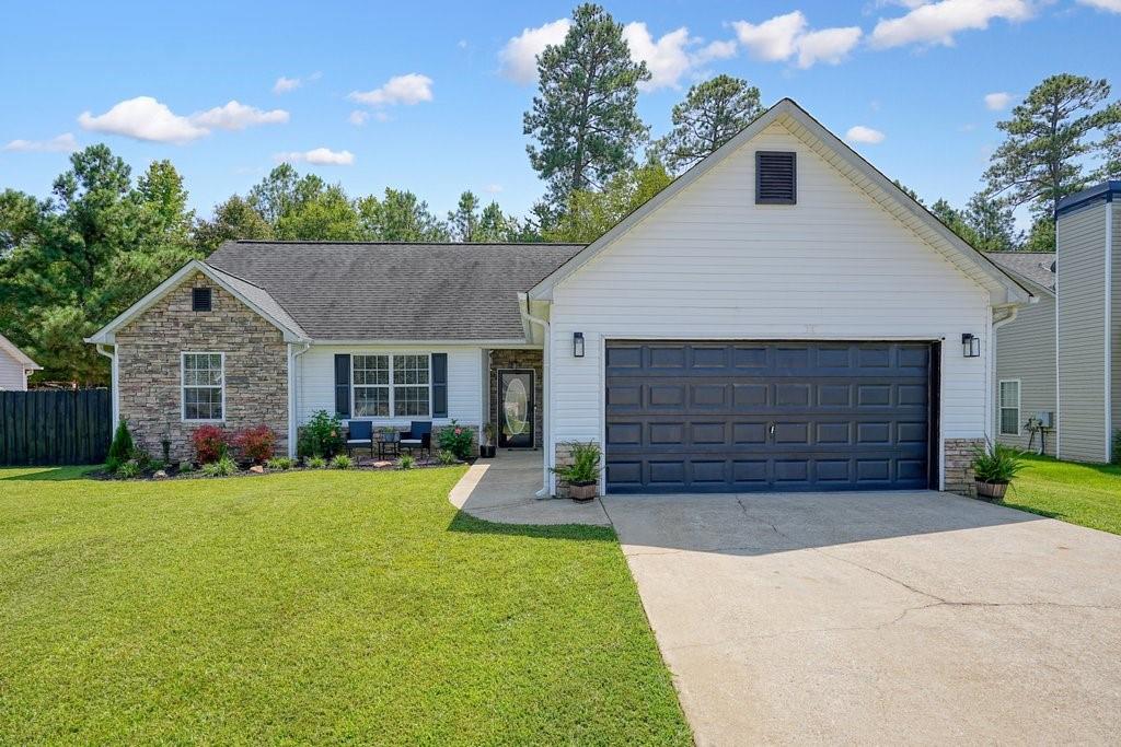 a front view of a house with a yard and garage