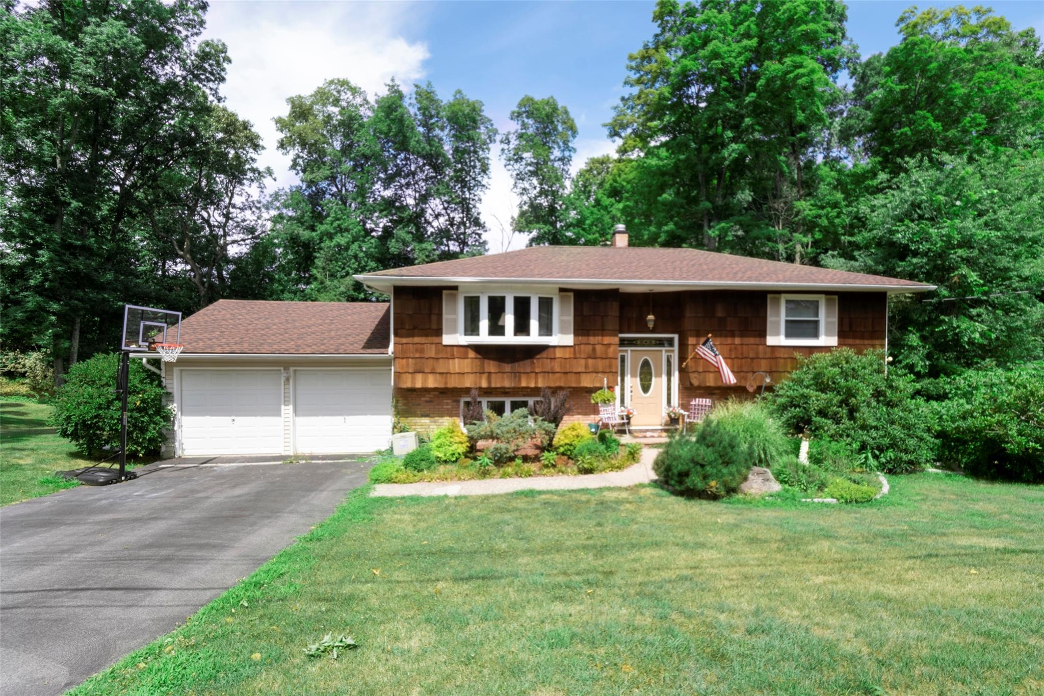 a front view of a house with a garden