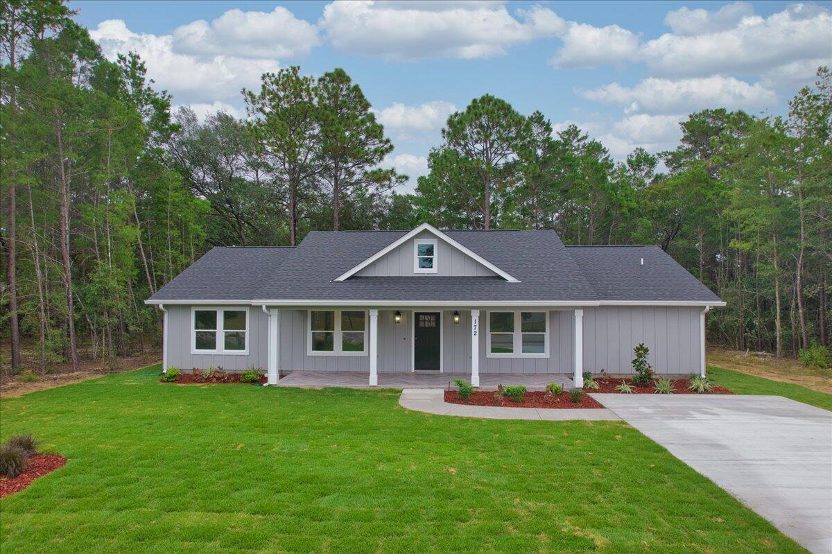 a front view of a house with a garden and porch