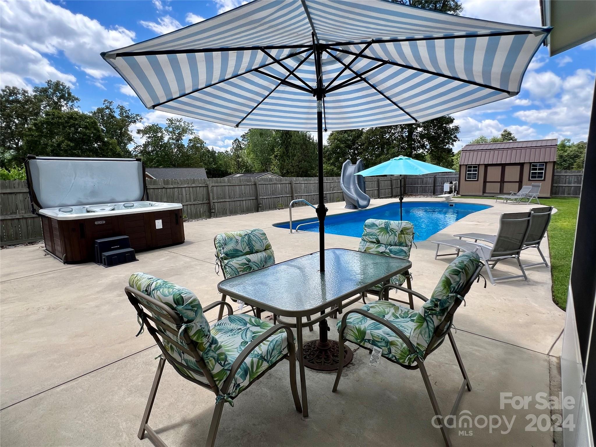 a patio with a patio table and chairs