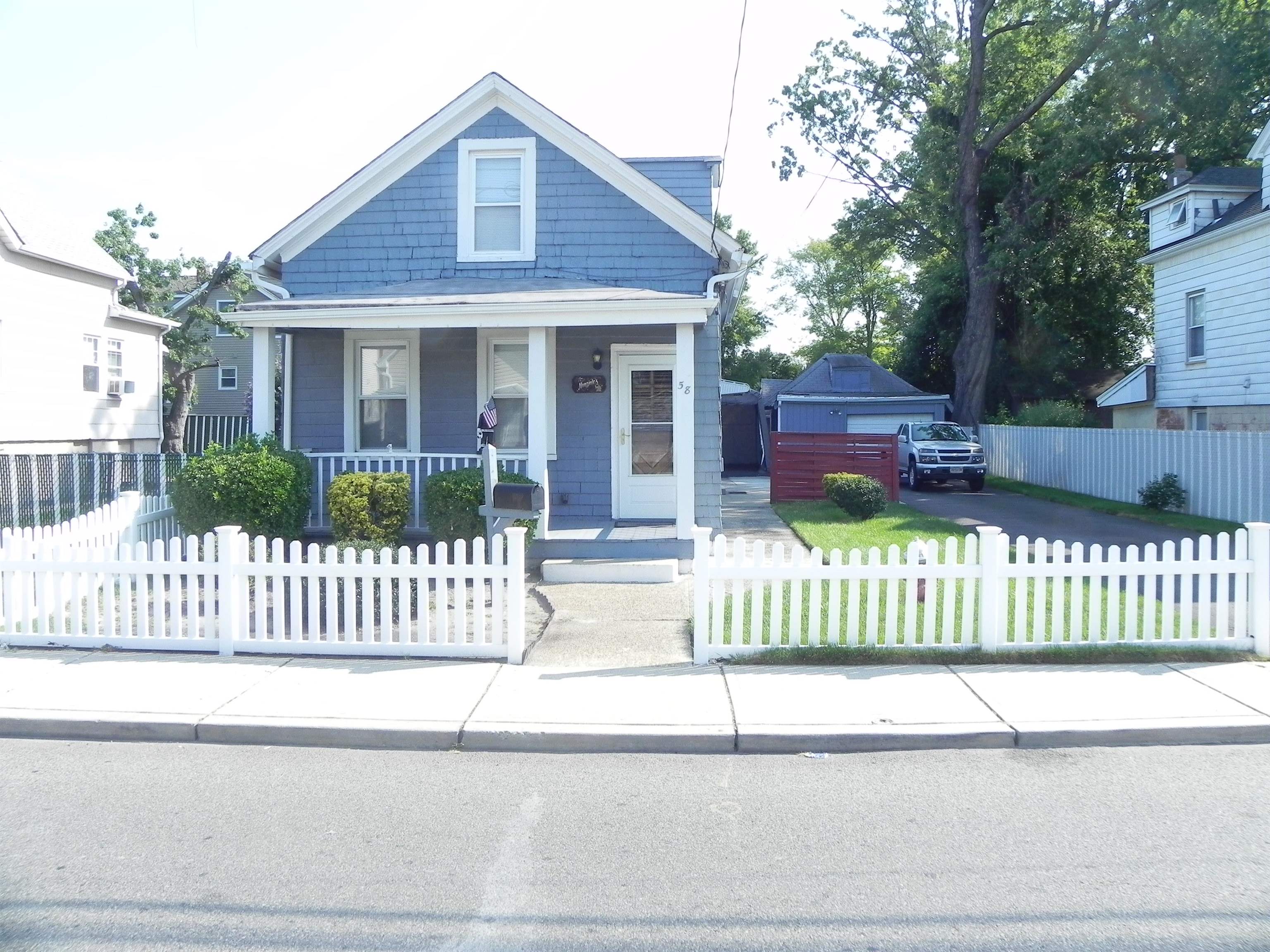 a front view of a house with a garden and deck