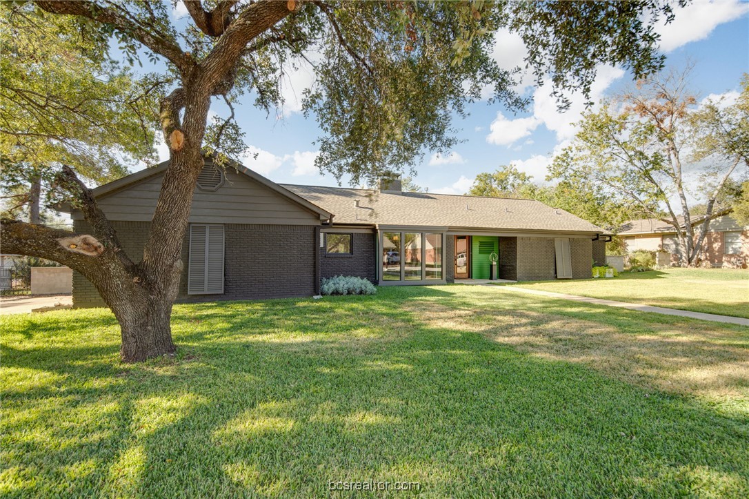 a front view of house with yard and green space