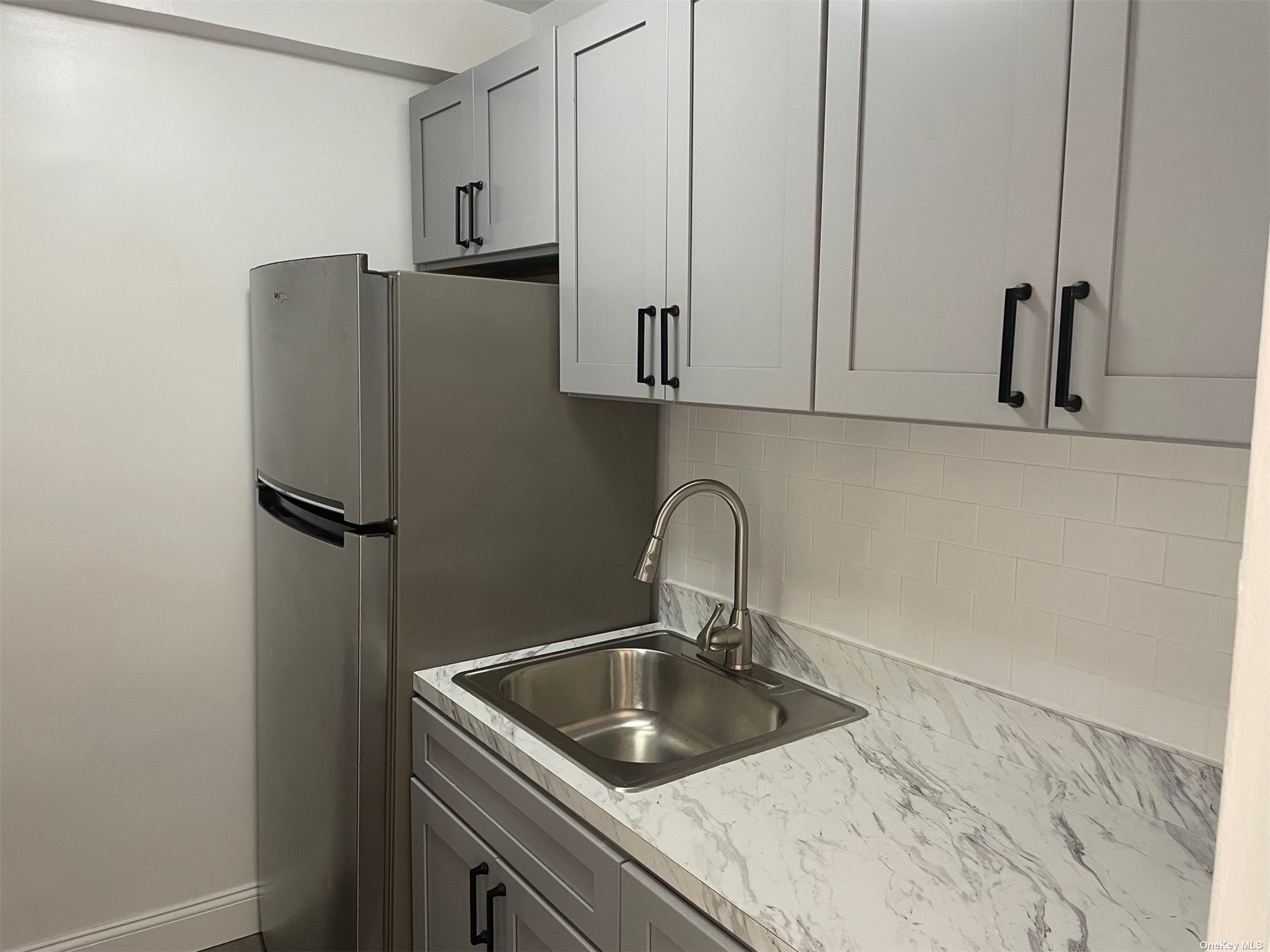 a kitchen with stainless steel appliances granite countertop a refrigerator and a sink