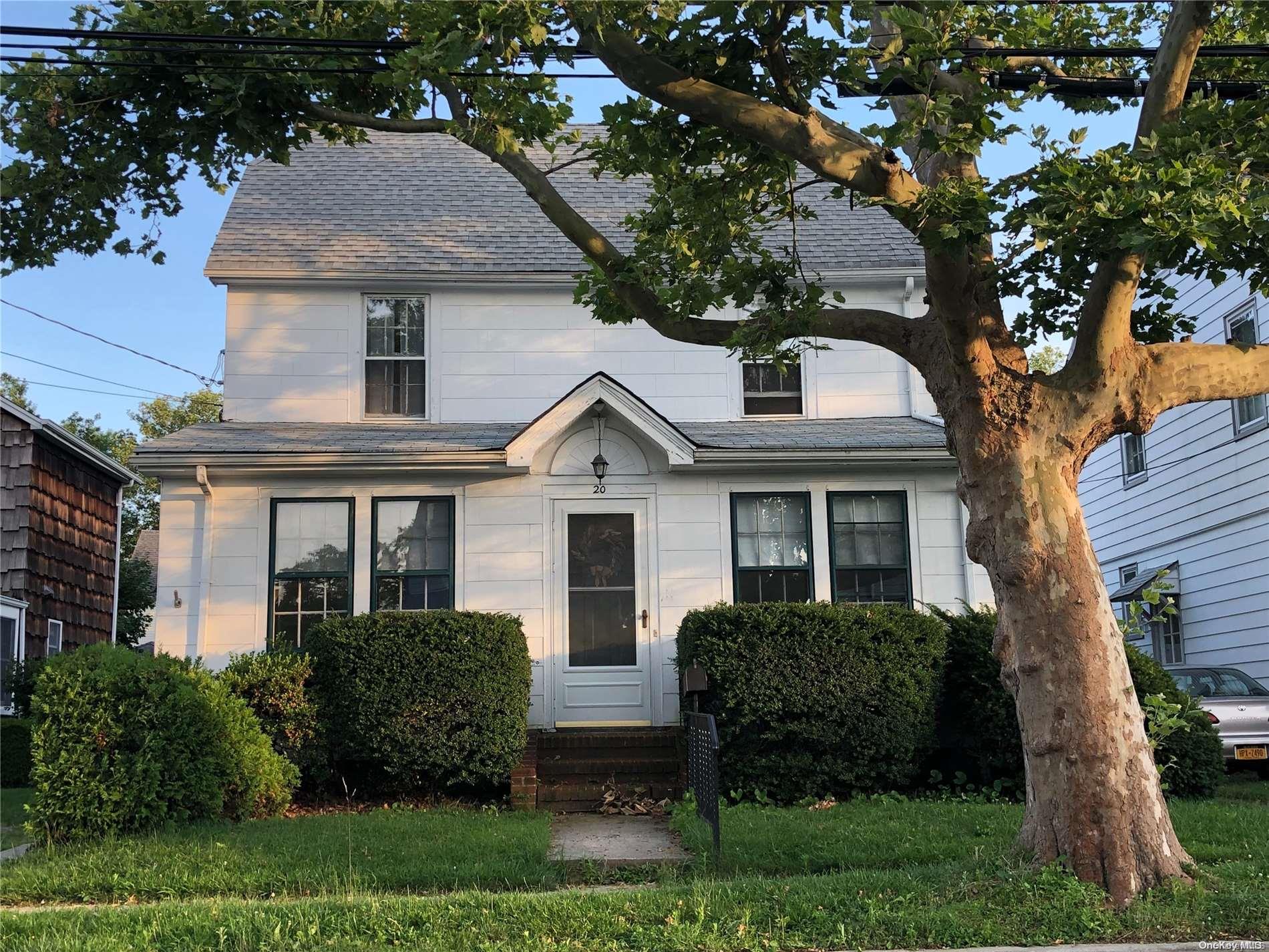 a front view of house with a garden