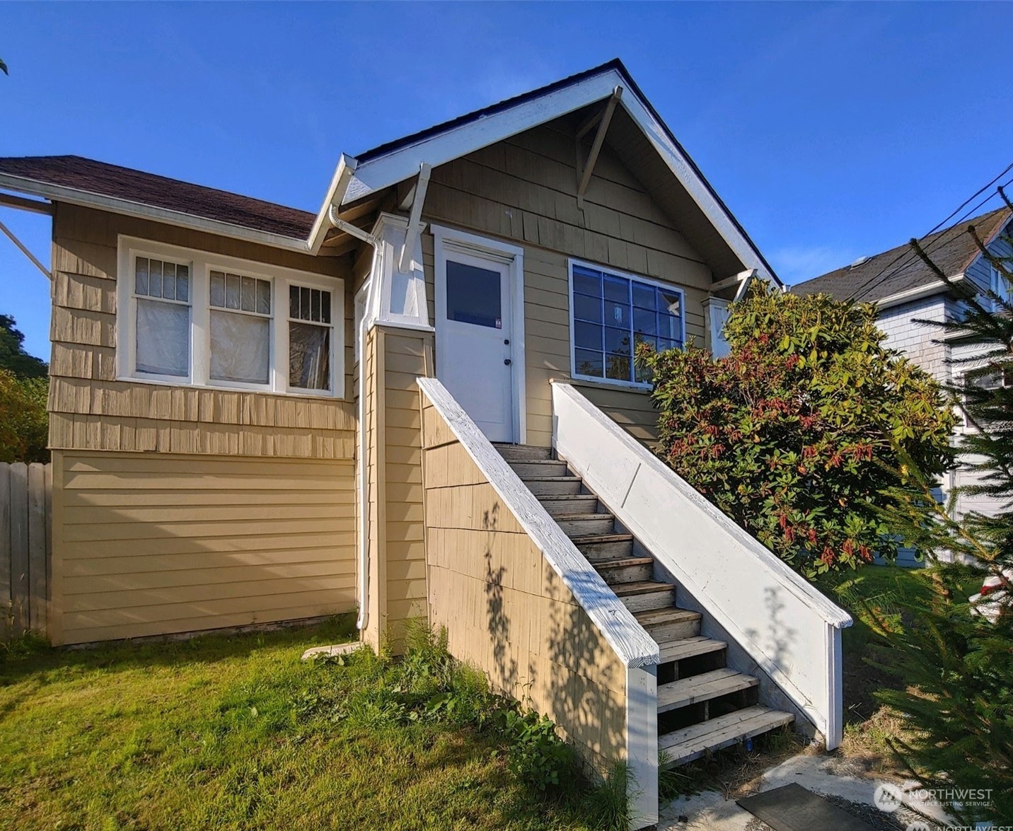 a view of a house with wooden fence and windows