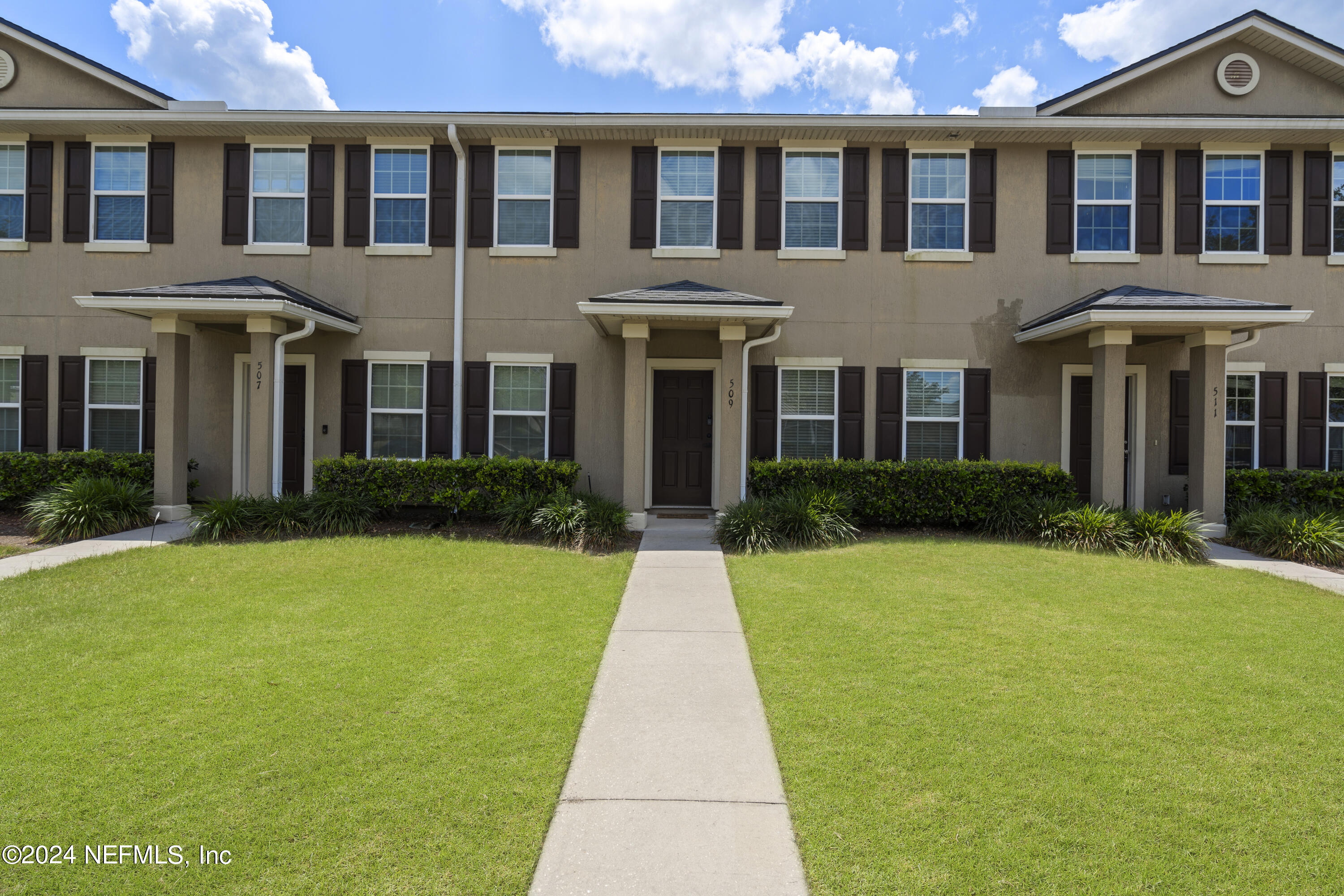 a front view of a house with garden