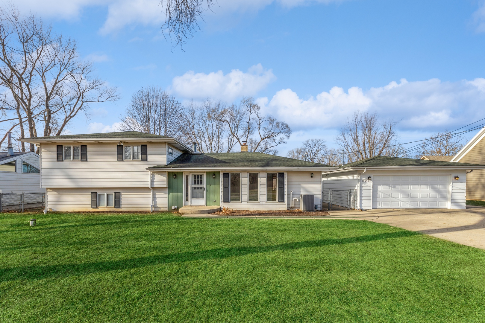 a front view of house with yard and green space