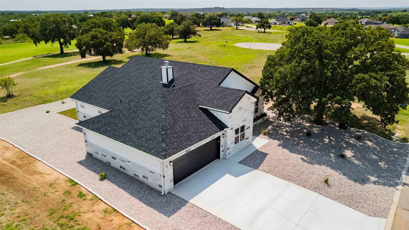 an aerial view of a house with a yard pool patio and outdoor seating