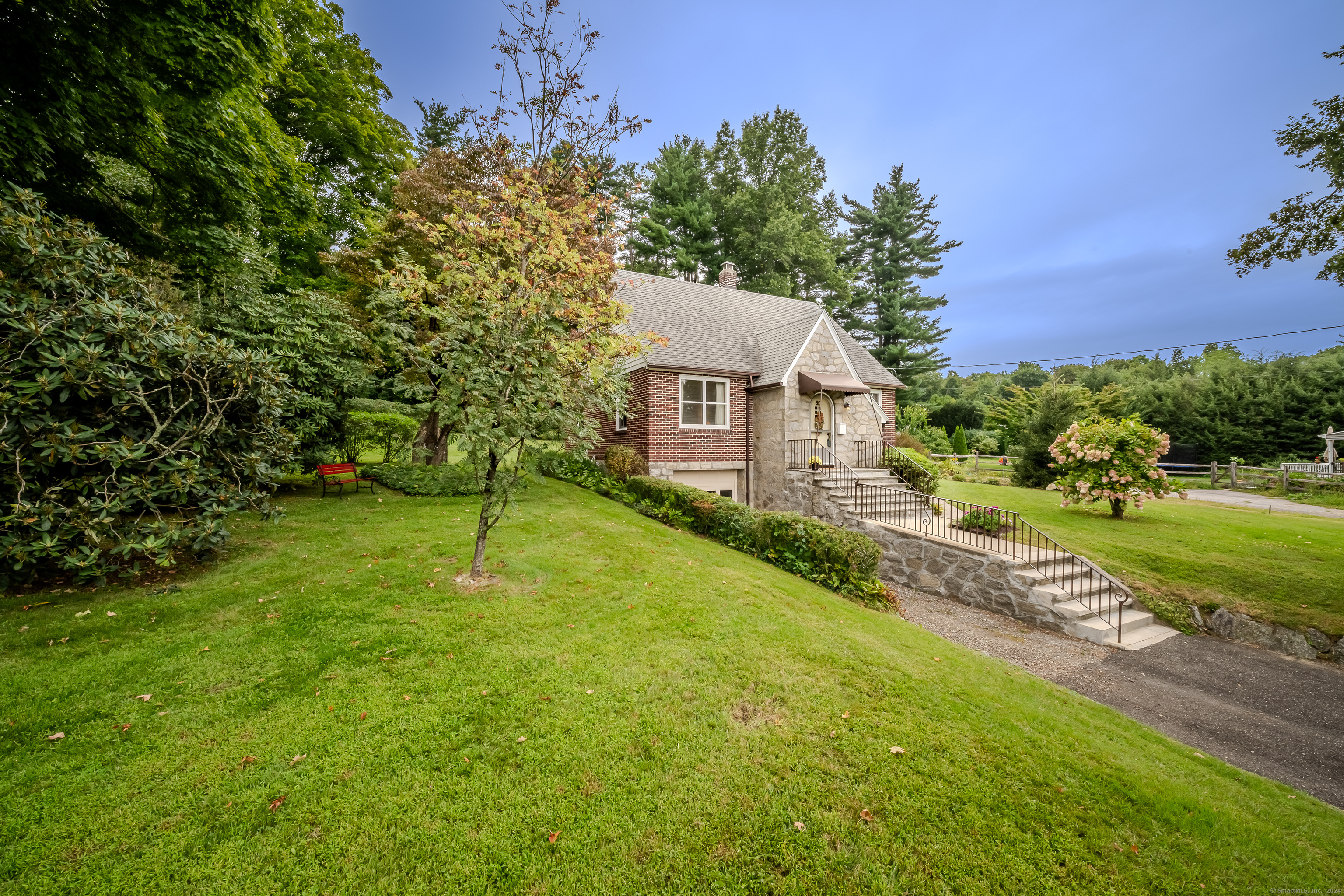 a view of a house with a yard and tree s