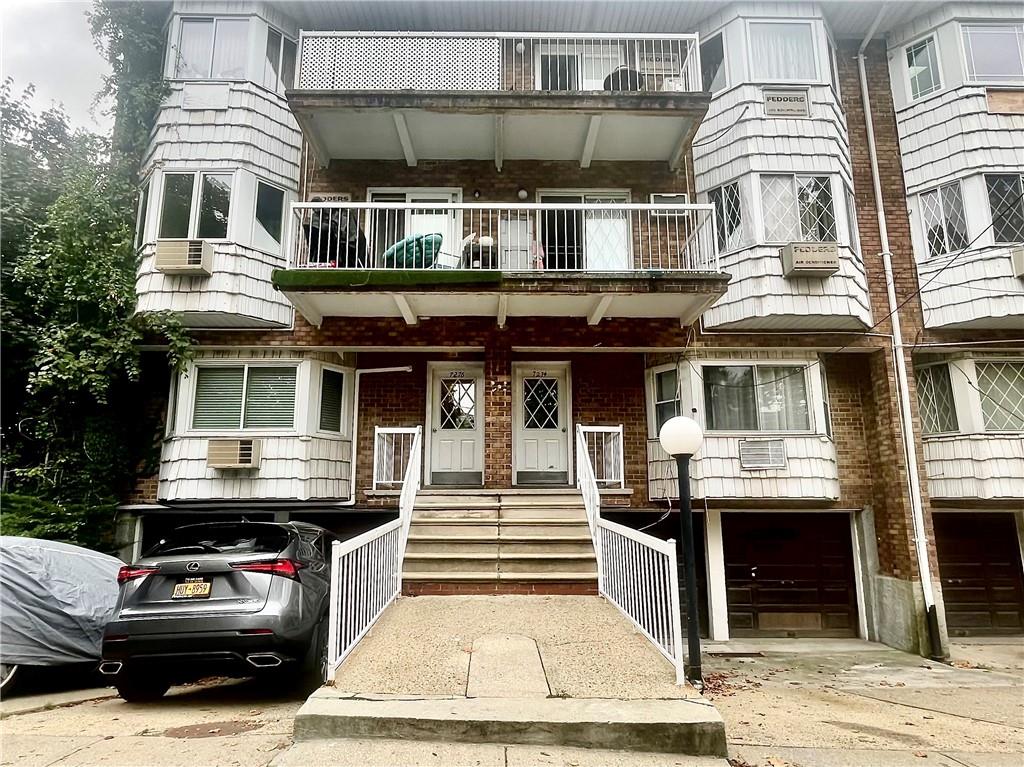 a front view of a residential apartment building with a yard