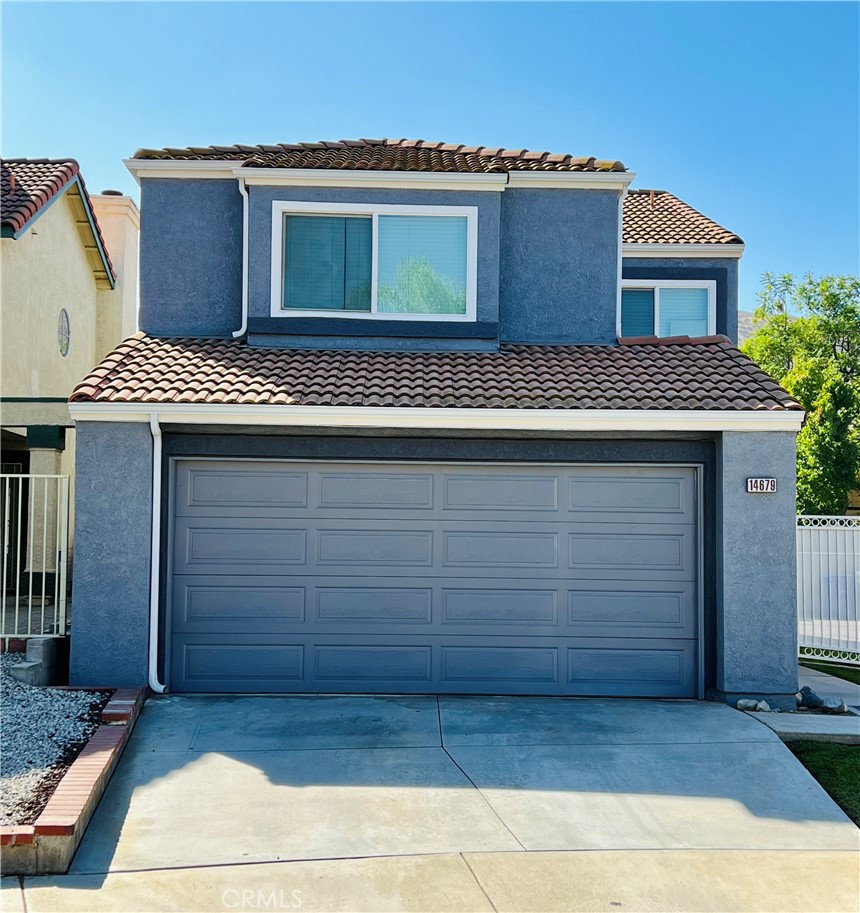 a front view of a house with a garage