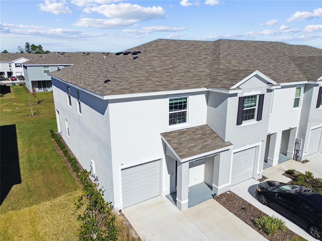 an aerial view of a house with a yard