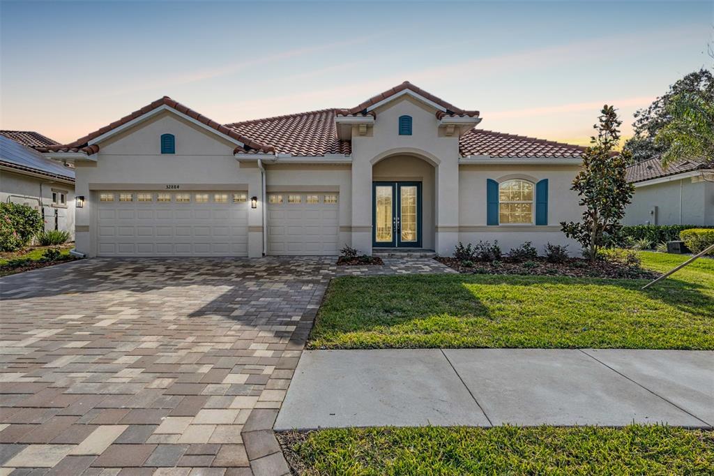 a front view of a house with a yard and garage