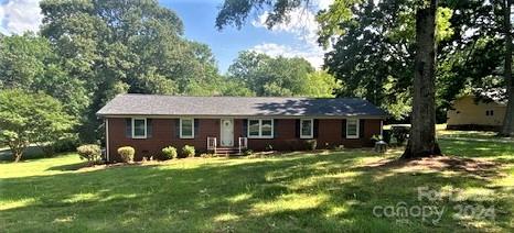 a view of a house with yard and a tree