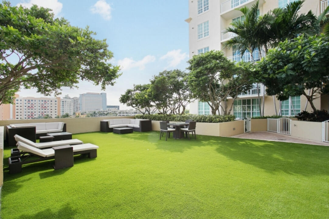 a swimming pool with outdoor seating and yard