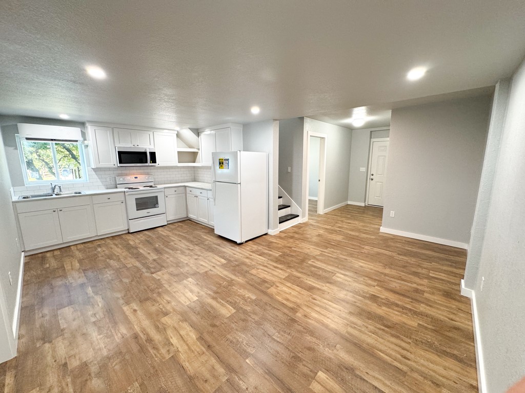 a large kitchen with kitchen island a sink stainless steel appliances and cabinets