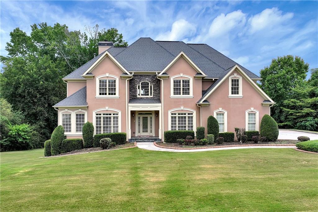 a front view of a house with a yard