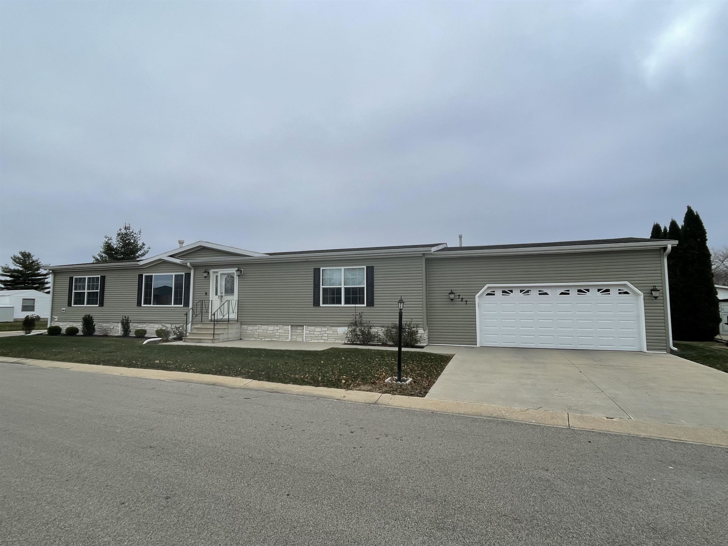 a view of a house with a yard and a garage