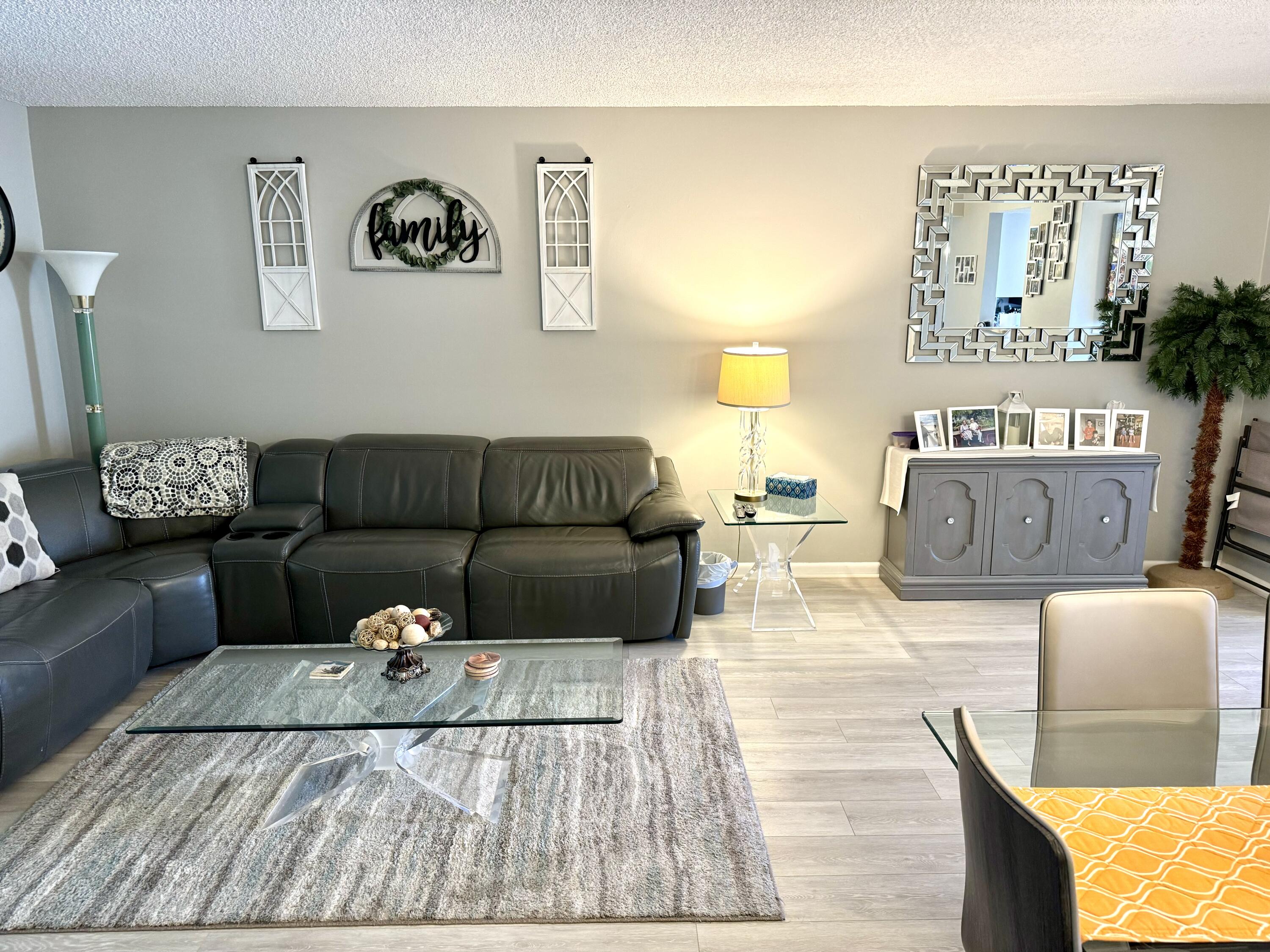 a living room with furniture and painting on the wall