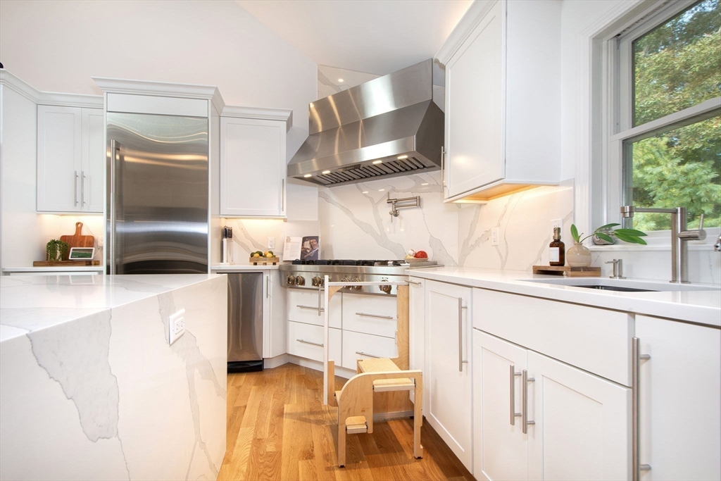 a kitchen with white cabinets and a stove