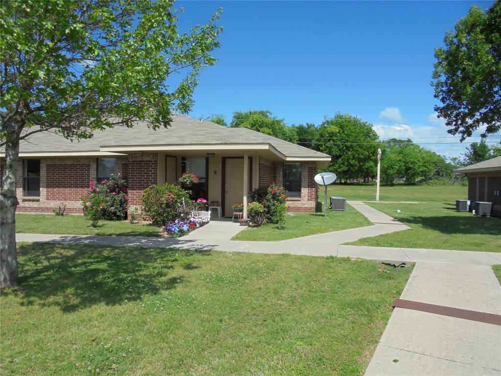 a view of a house with a yard porch and sitting area