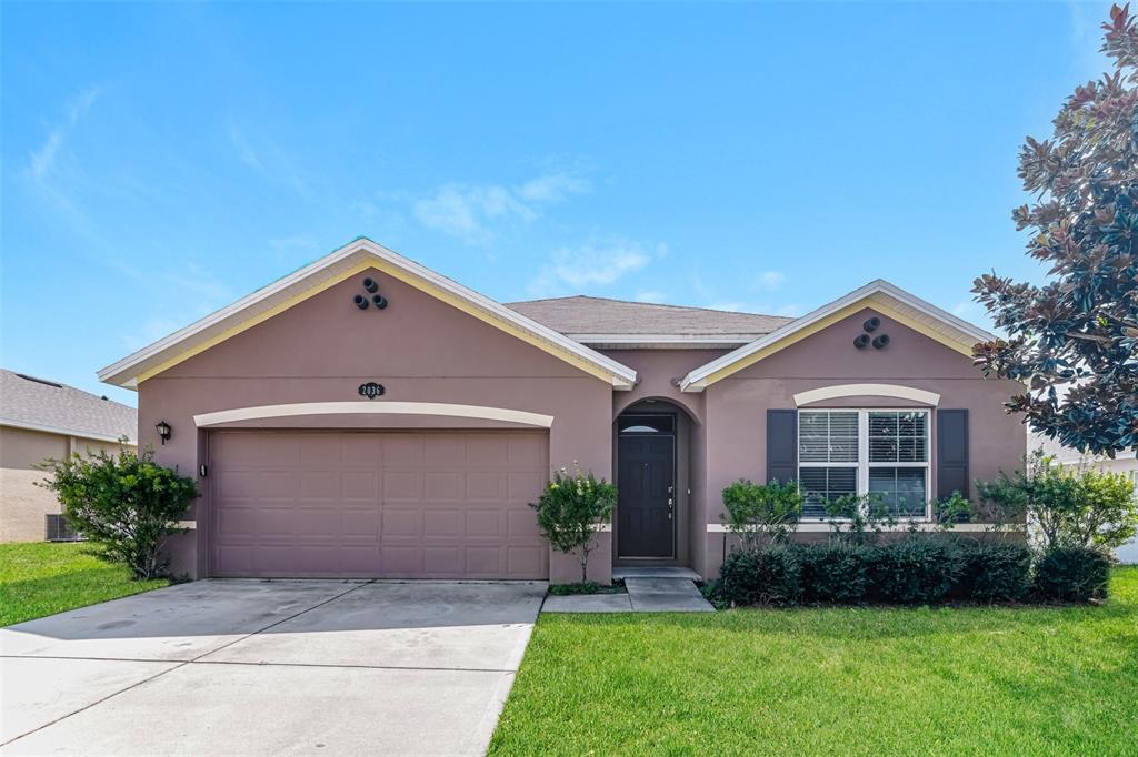 a front view of a house with a yard and garage