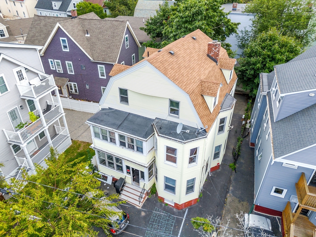 an aerial view of multiple houses with a yard