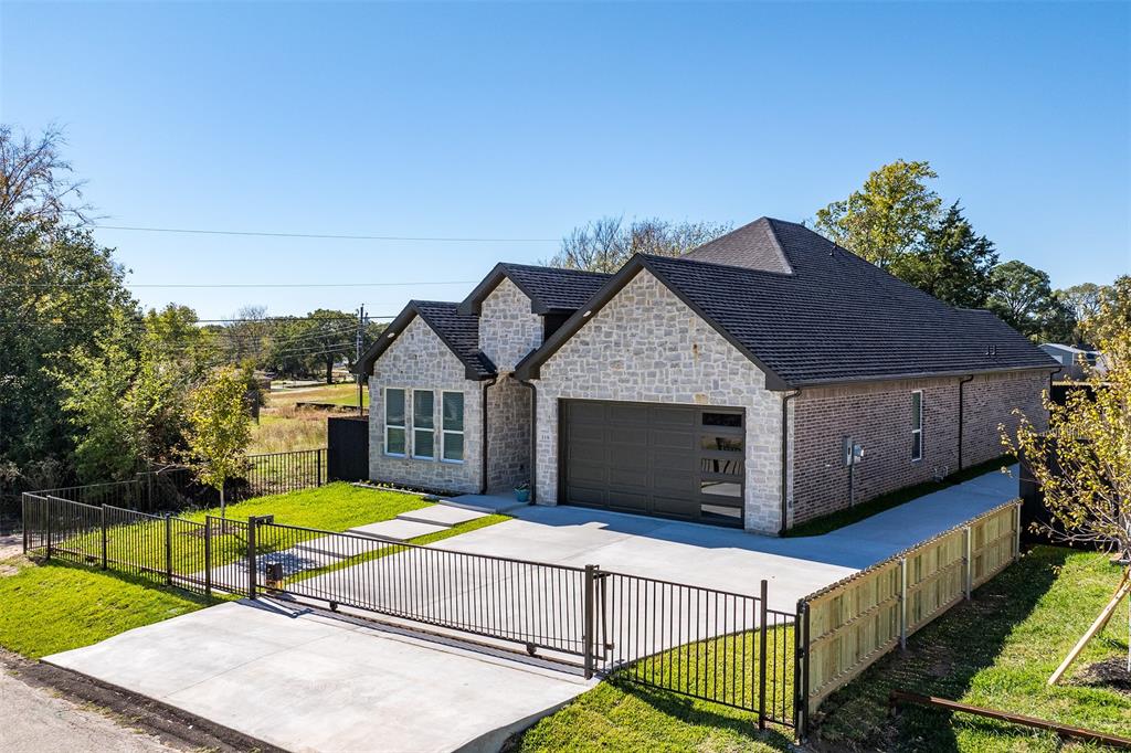 a view of a house with wooden fence