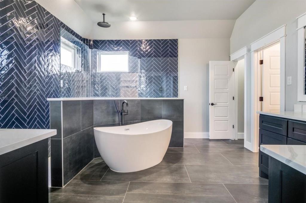 a bathroom with a bathtub and shower