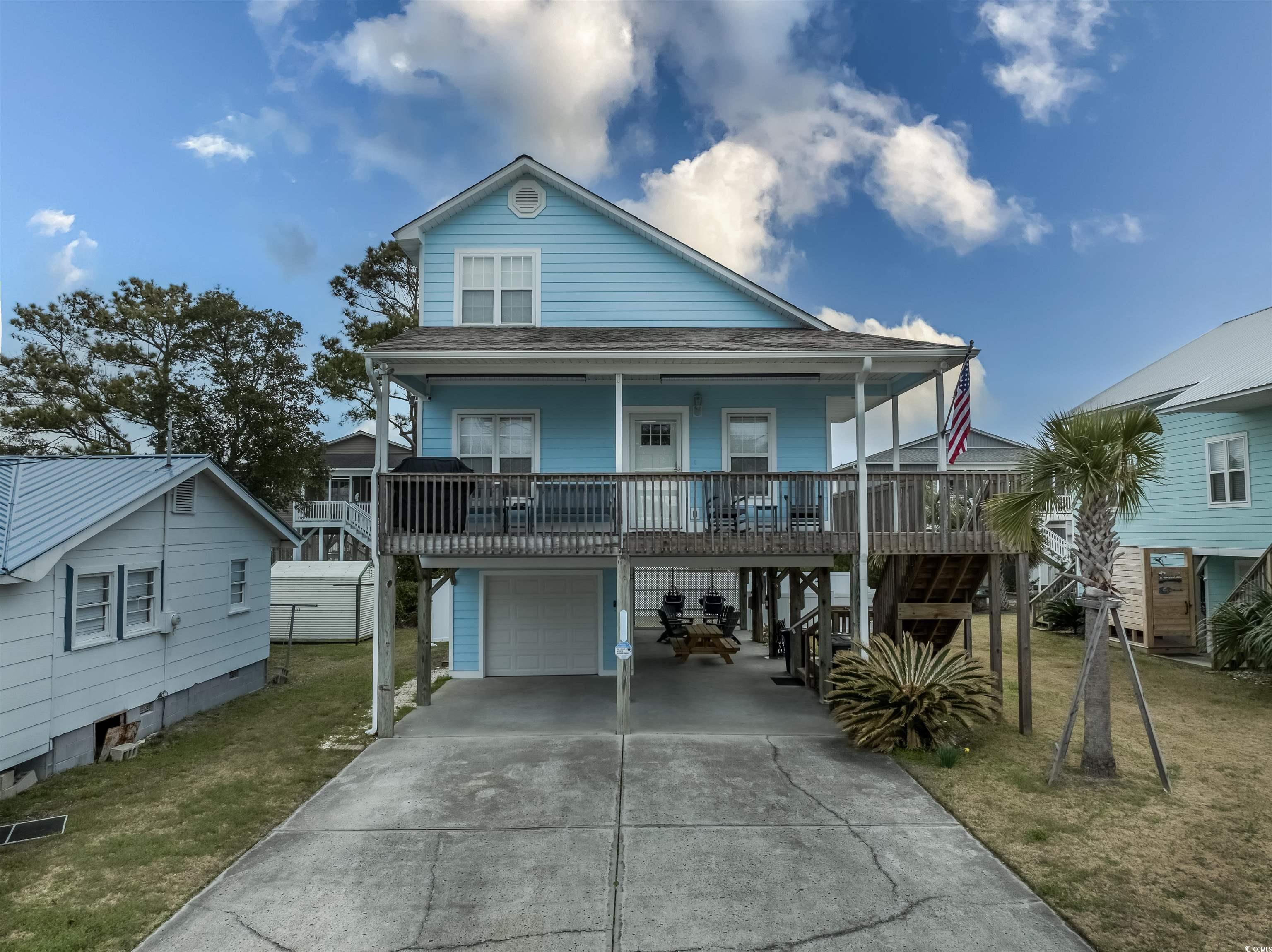 View of front of property featuring a carport, a p