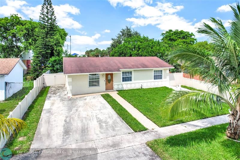 a aerial view of a house with a yard