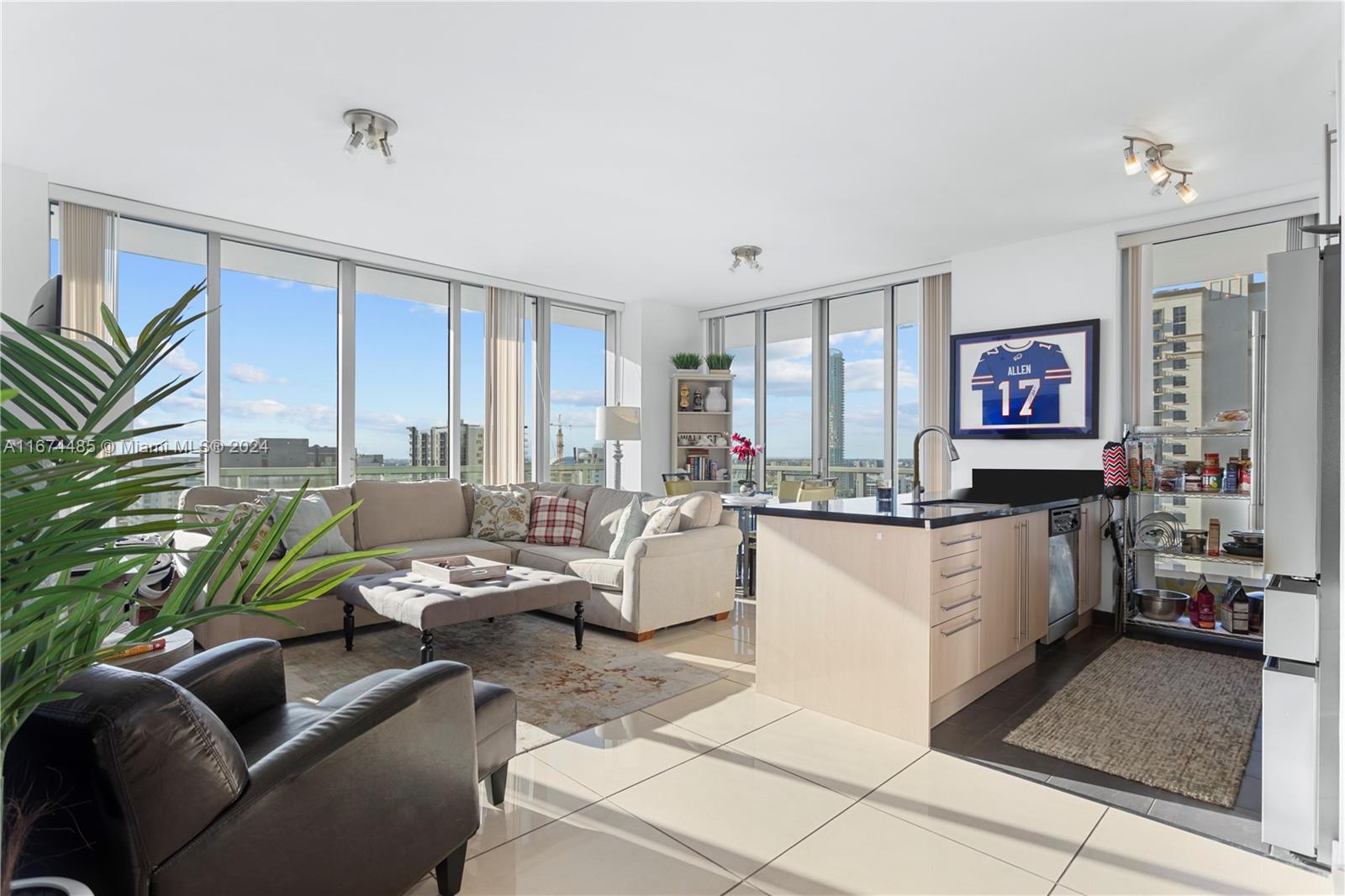 a living room with furniture and large window