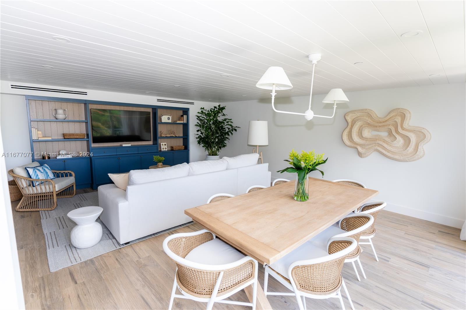 a living room with furniture dining room and wooden floor