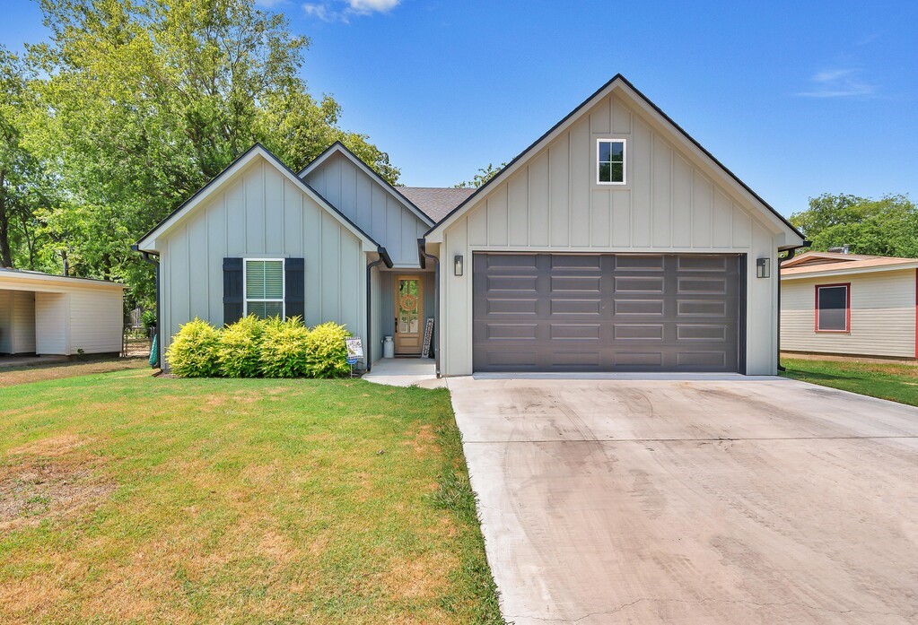 a view of backyard of house and garage