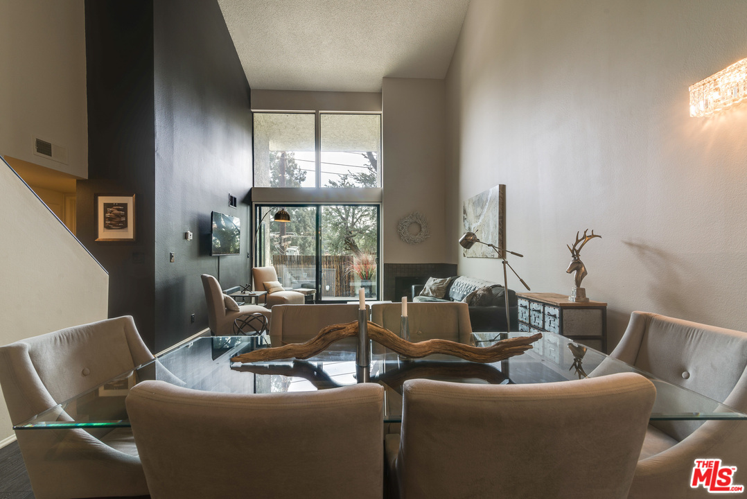 a living room with furniture and large windows