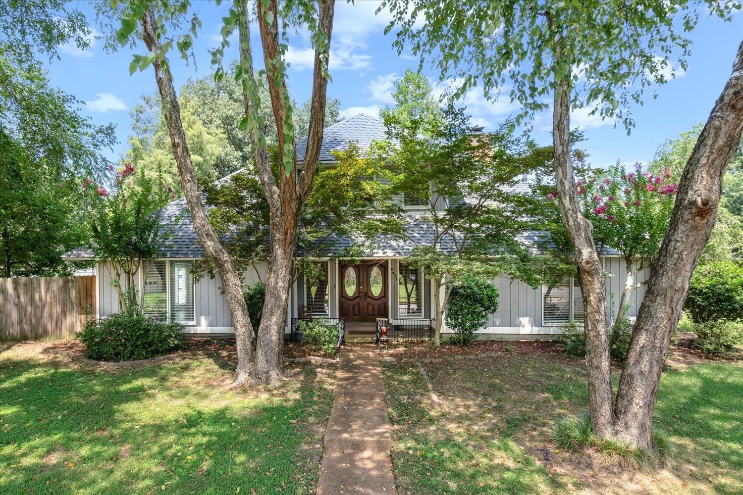 a front view of a house with garden