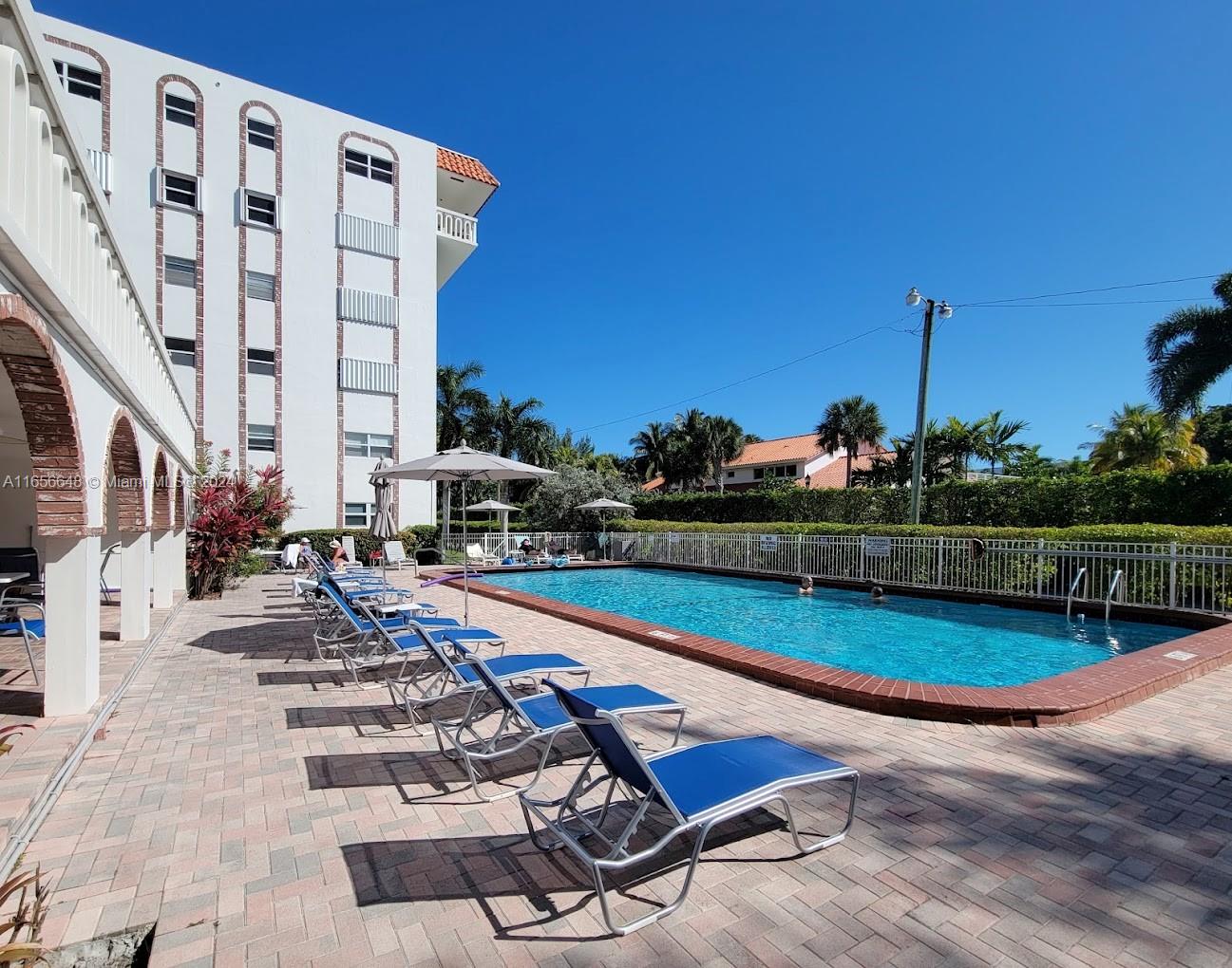 a view of a swimming pool with outdoor seating