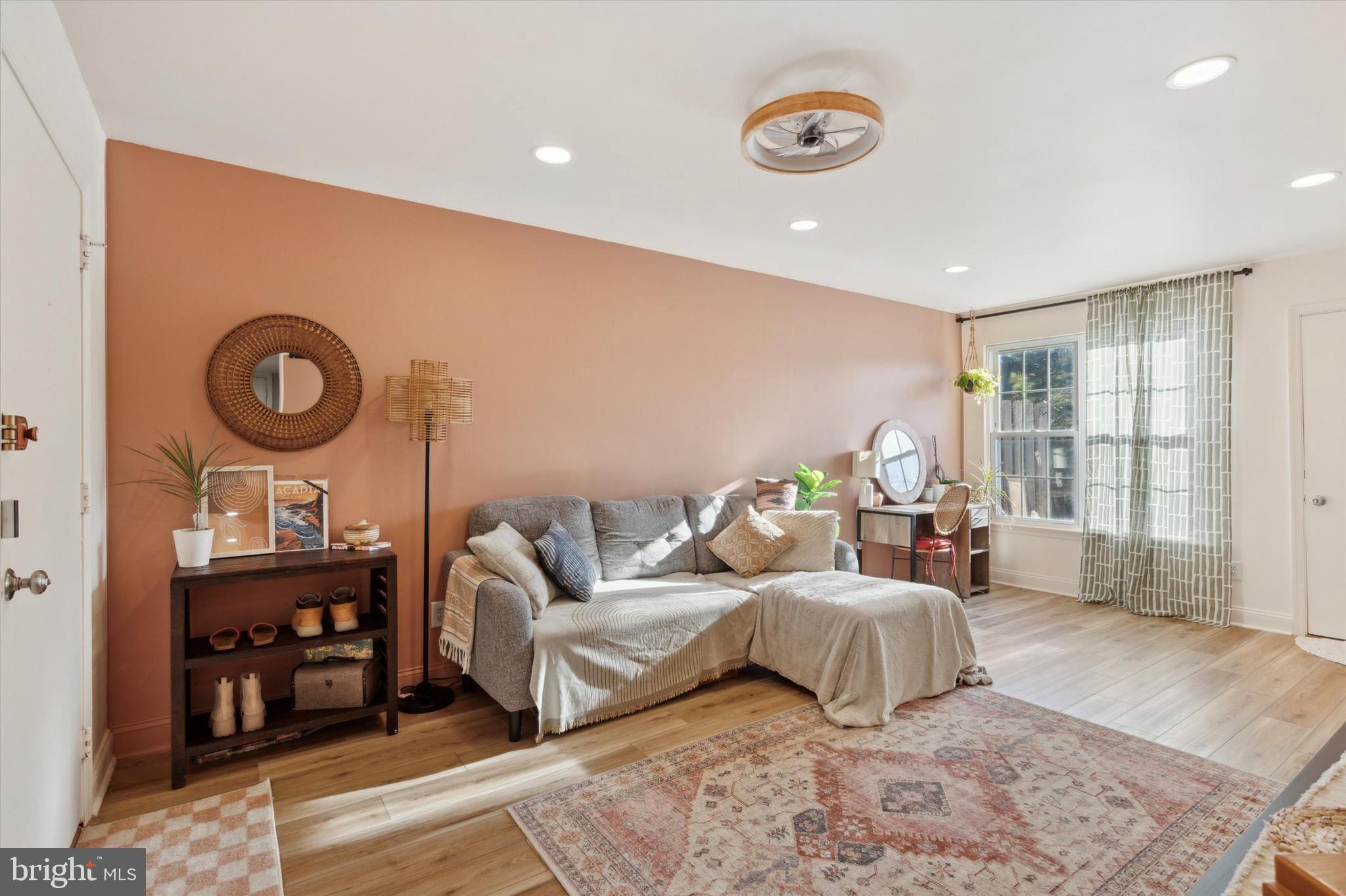 a spacious bedroom with a bed a couch and a large window