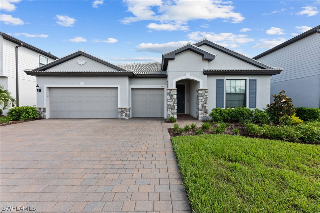 a front view of a house with a yard and garage