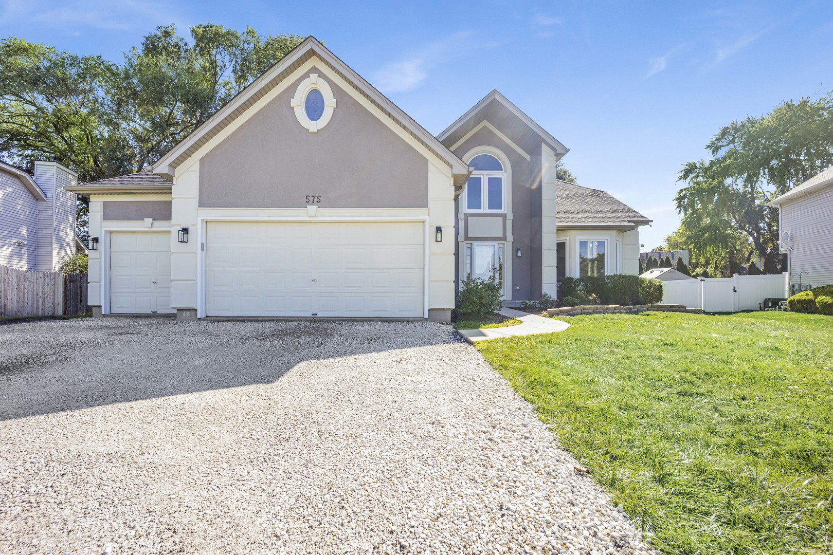 a front view of house with yard and green space