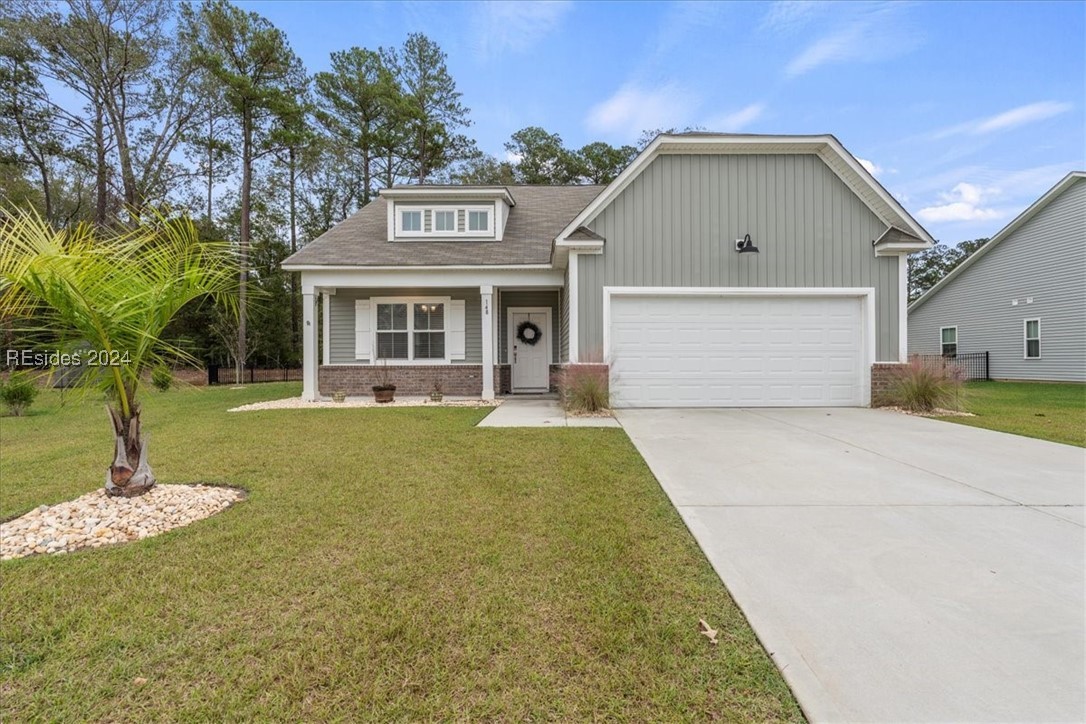 Craftsman-style home featuring a garage and a fron