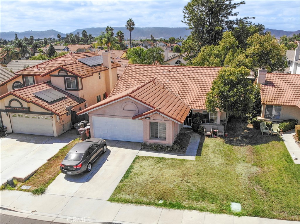 an aerial view of a house with garden fireplace and outdoor seating